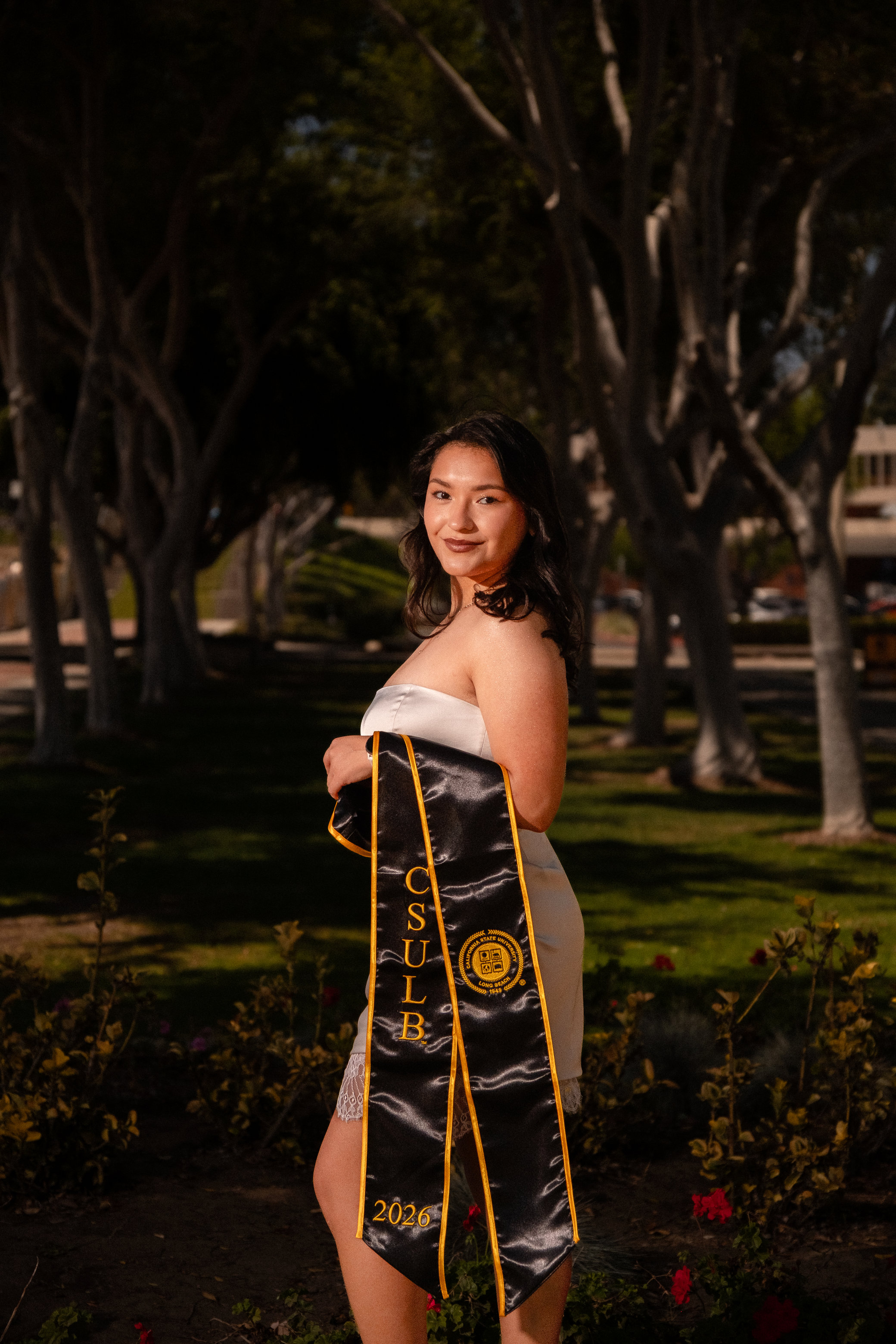 Graduate holding sash