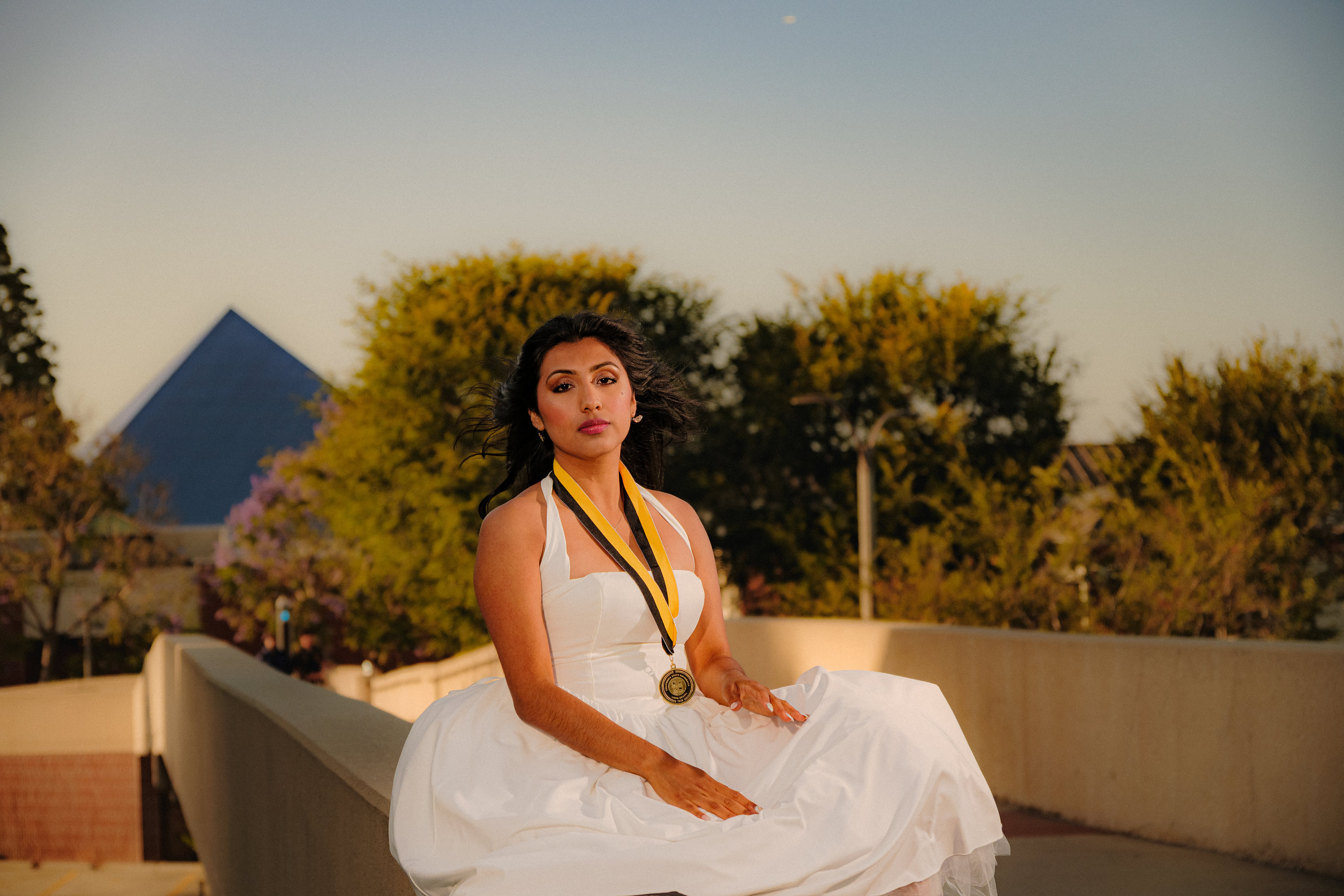 Woman sitting on guardrail 