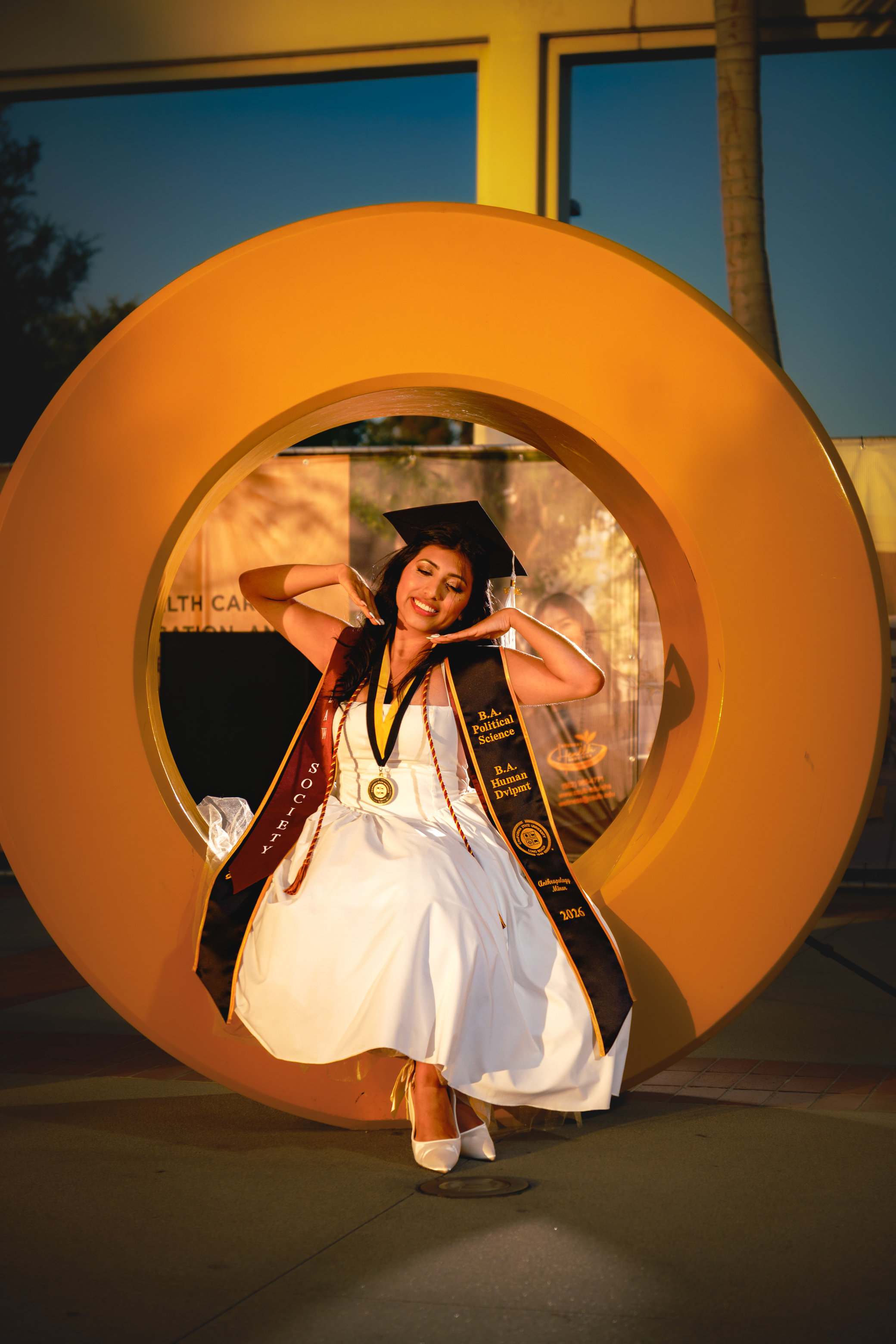 Woman sitting inside large letter O